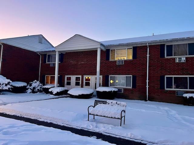 view of snow covered rear of property