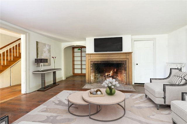 living room with a fireplace and dark hardwood / wood-style floors