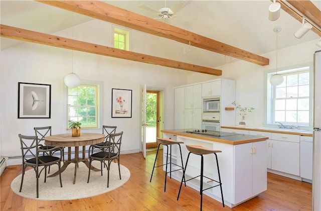 kitchen featuring a kitchen island, white cabinetry, and pendant lighting