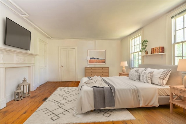 bedroom featuring light hardwood / wood-style flooring and multiple windows