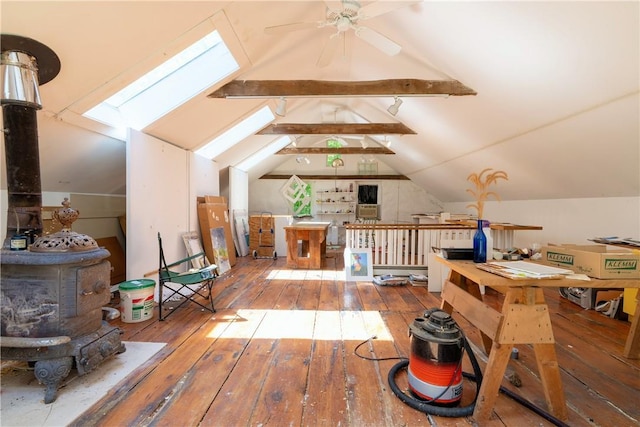 additional living space with ceiling fan, wood-type flooring, and lofted ceiling with skylight