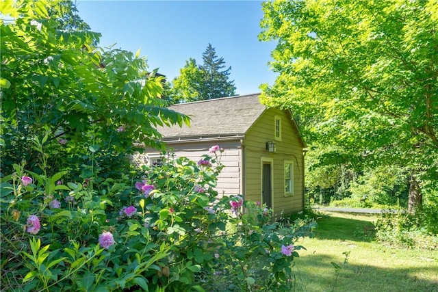 view of outbuilding featuring a yard