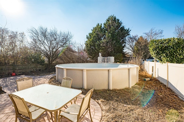 view of patio / terrace with a fenced in pool