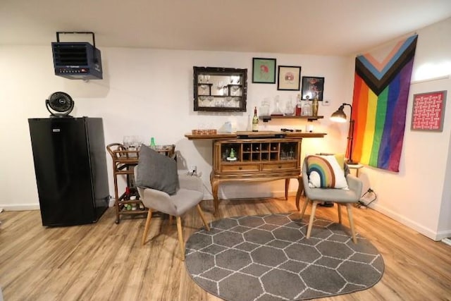 sitting room with wood-type flooring