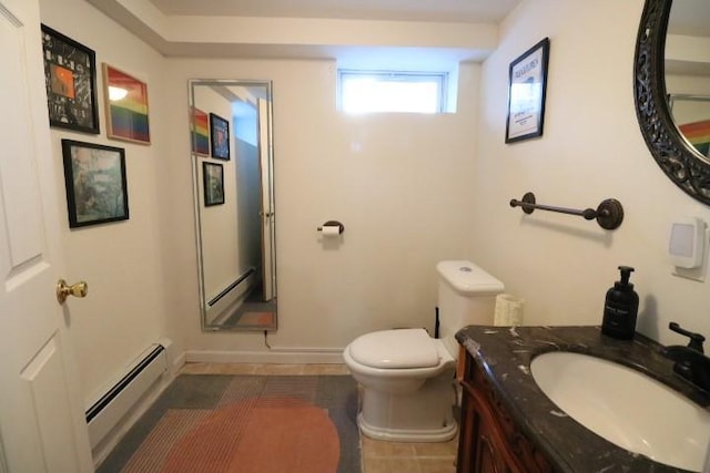 bathroom with a baseboard heating unit, toilet, tile patterned flooring, and vanity