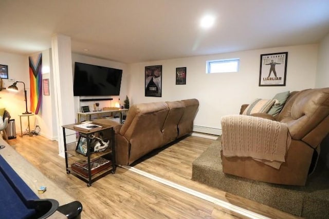 living room featuring baseboard heating and light hardwood / wood-style floors