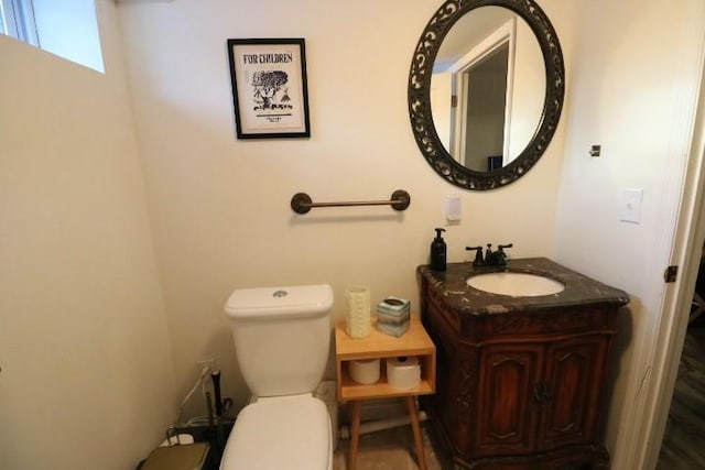 bathroom featuring toilet and vanity