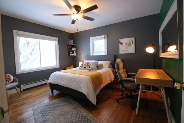 bedroom with ceiling fan, baseboard heating, and wood-type flooring