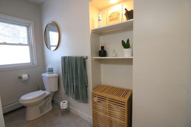 bathroom featuring toilet, a baseboard heating unit, and plenty of natural light