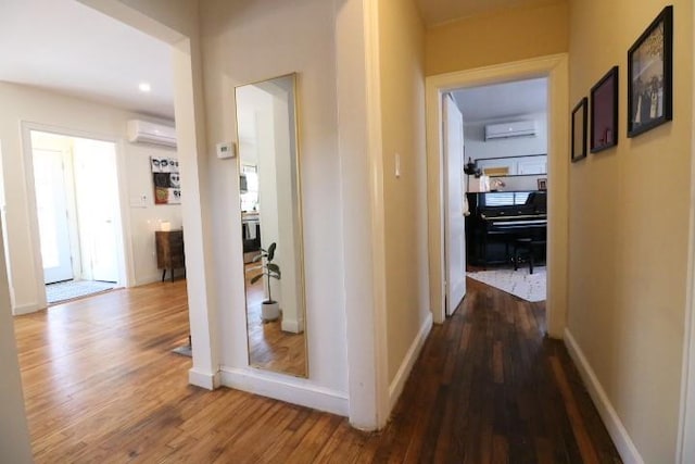 hallway featuring hardwood / wood-style floors and a wall mounted air conditioner