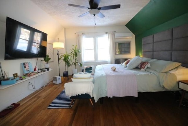 bedroom featuring ceiling fan, lofted ceiling, radiator heating unit, and hardwood / wood-style flooring