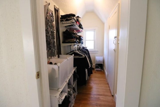 laundry area featuring wood-type flooring and washing machine and dryer