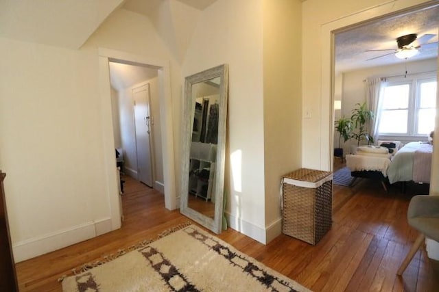 hallway with hardwood / wood-style floors