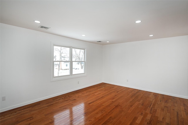 unfurnished room featuring hardwood / wood-style flooring