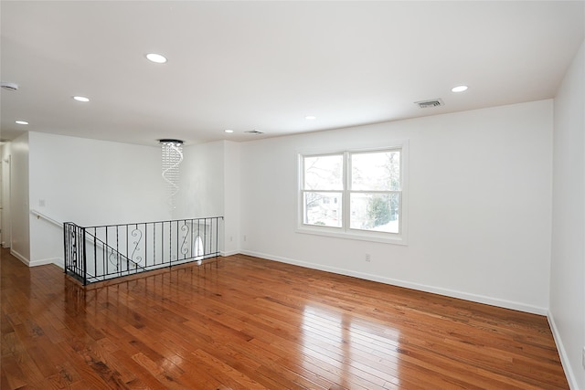 spare room with hardwood / wood-style flooring