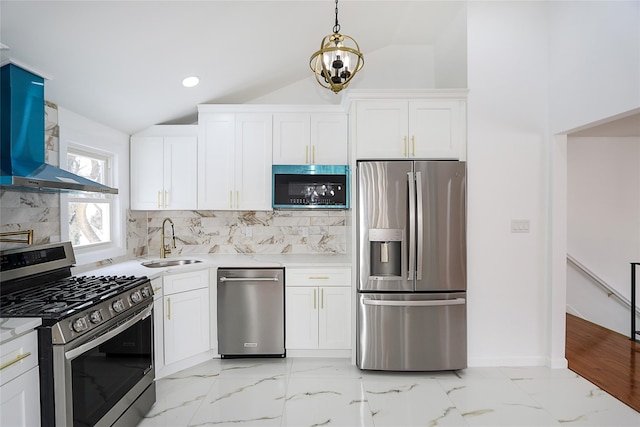 kitchen with white cabinetry, stainless steel appliances, vaulted ceiling, wall chimney exhaust hood, and sink