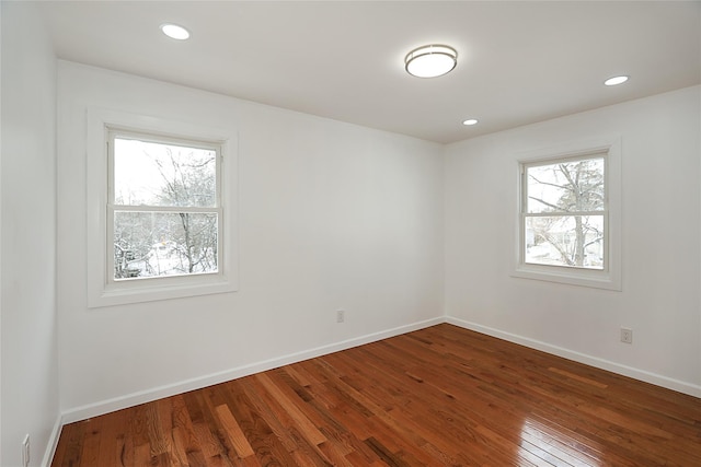 empty room with hardwood / wood-style floors