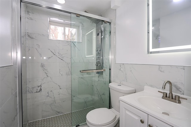 bathroom featuring toilet, tile walls, an enclosed shower, and vanity