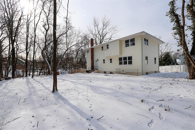 view of snow covered back of property