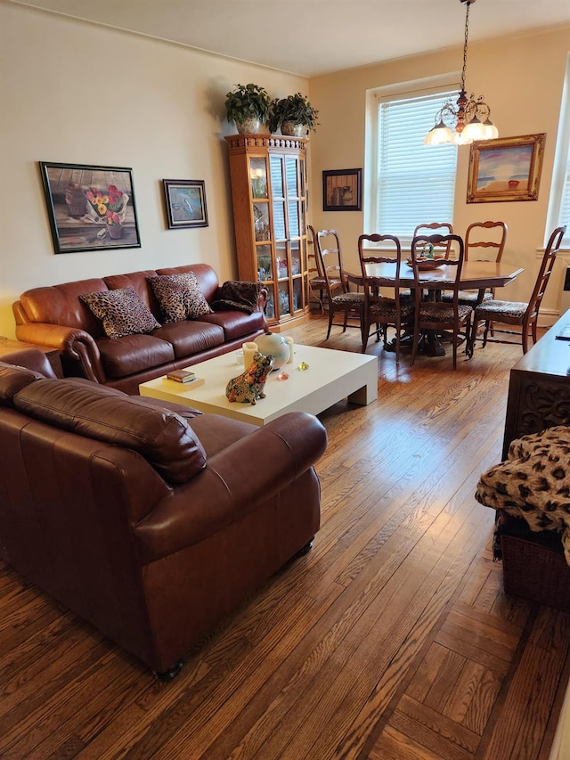 living room featuring an inviting chandelier and hardwood / wood-style flooring