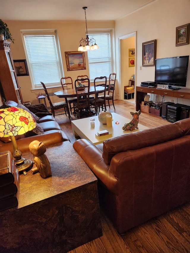 living room featuring hardwood / wood-style floors and an inviting chandelier