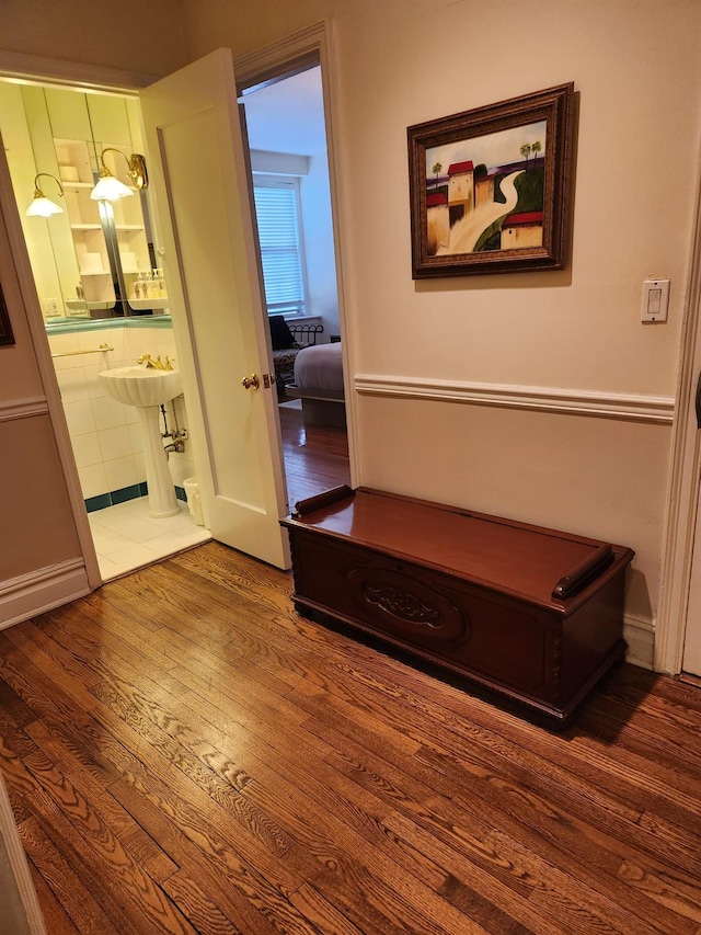 corridor with hardwood / wood-style flooring