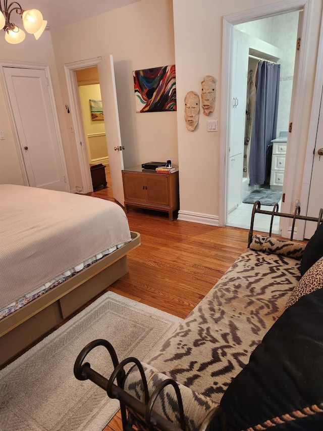 bedroom with light wood-type flooring, a walk in closet, and a closet