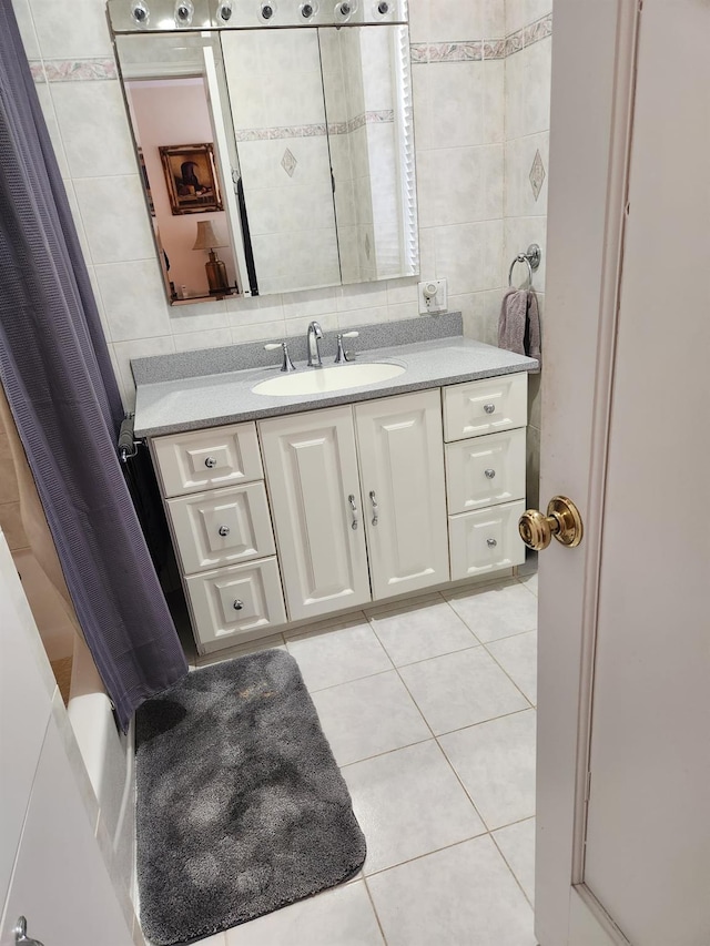 bathroom with tasteful backsplash, vanity, tile walls, and tile patterned floors