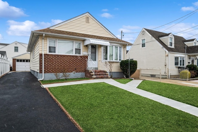 view of front facade with a front lawn, a garage, and an outdoor structure