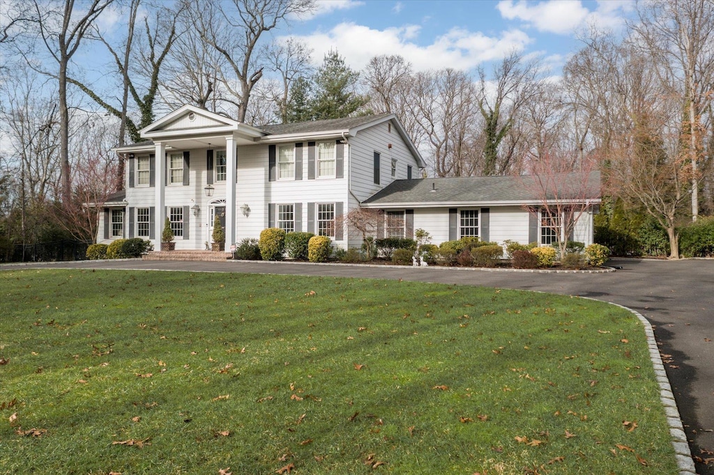 greek revival house featuring a front lawn