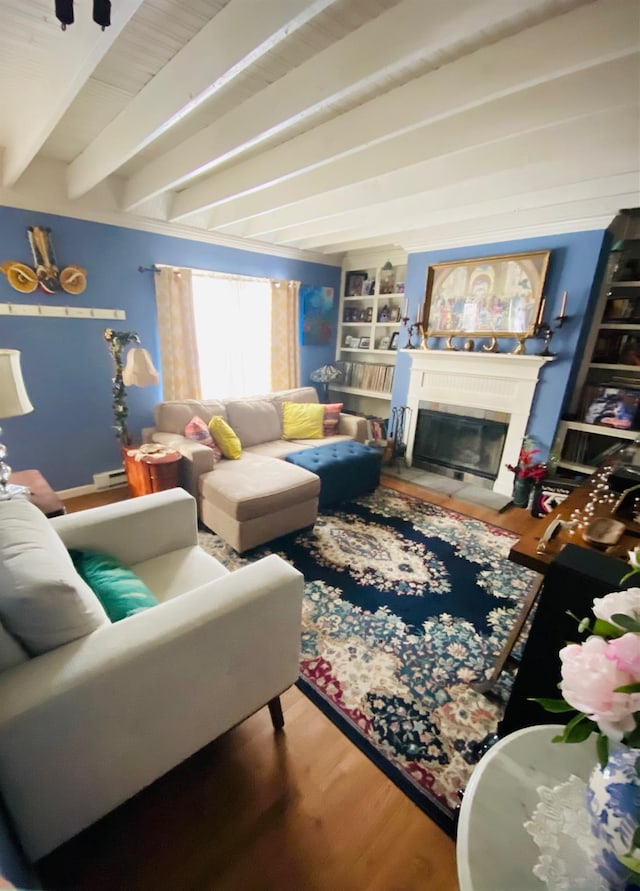 living room featuring built in shelves, beamed ceiling, and hardwood / wood-style flooring