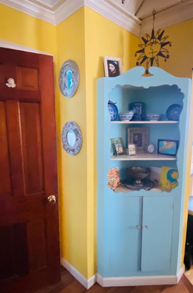 interior details with hardwood / wood-style flooring and crown molding