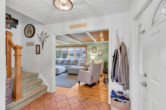 foyer featuring stairs, light tile patterned flooring, and wood ceiling