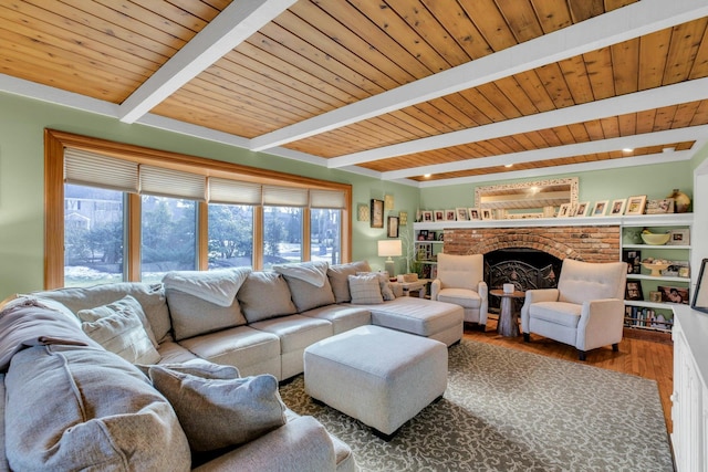 living room with wood ceiling, beam ceiling, a fireplace, and wood finished floors