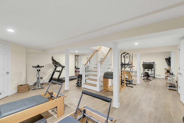 exercise area with light wood-type flooring, baseboards, and recessed lighting