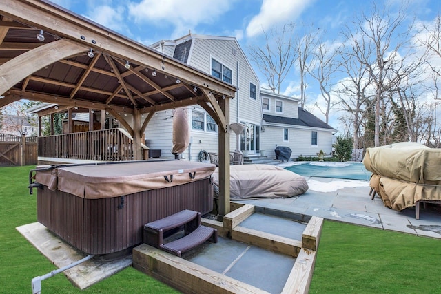 exterior space featuring a hot tub, a fenced in pool, a patio, fence, and a gazebo