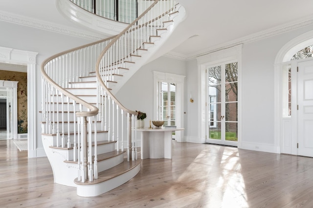 entryway featuring hardwood / wood-style flooring and ornamental molding