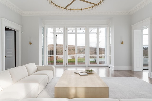 living room with ornamental molding and light hardwood / wood-style floors