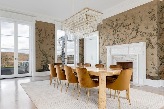 dining room featuring french doors, ornamental molding, and a chandelier