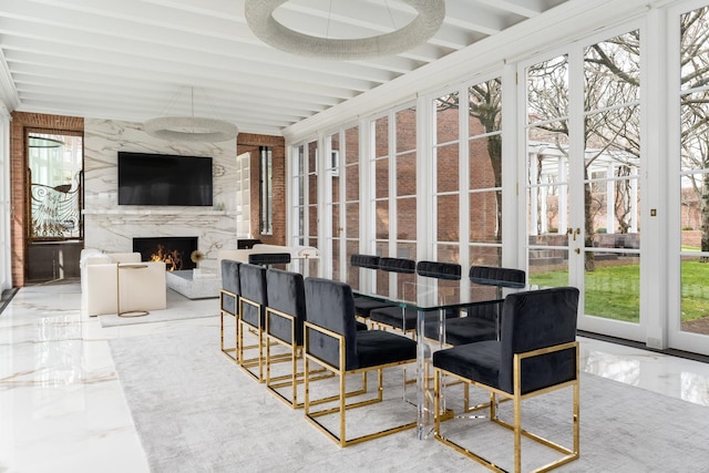 sunroom / solarium with a premium fireplace