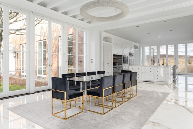 dining space with crown molding and plenty of natural light