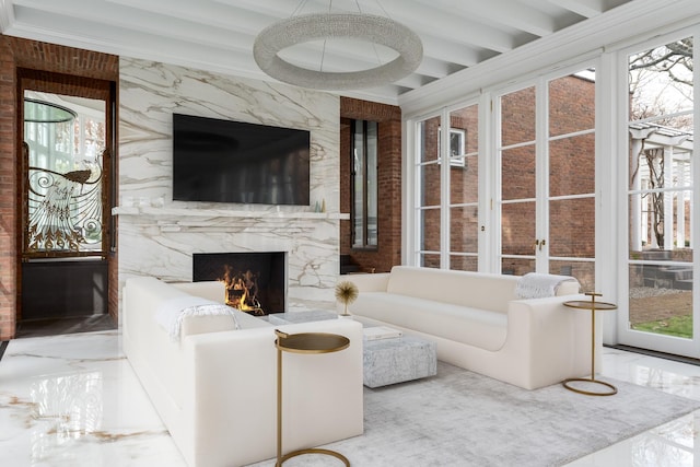 living room featuring ornamental molding and a fireplace