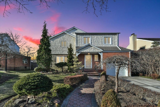 front facade with a garage and a lawn