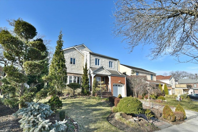 view of property featuring a front yard and a garage