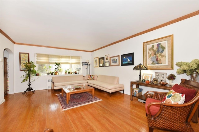 living room with ornamental molding, hardwood / wood-style floors, and radiator heating unit