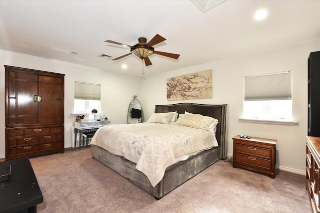 bedroom with ceiling fan and light colored carpet