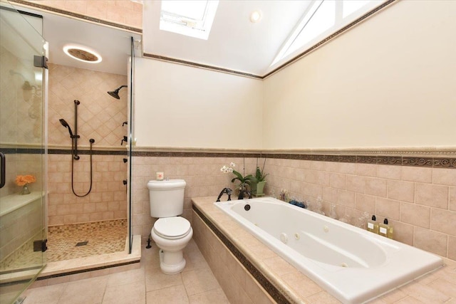 bathroom with toilet, separate shower and tub, tile walls, lofted ceiling, and tile patterned floors