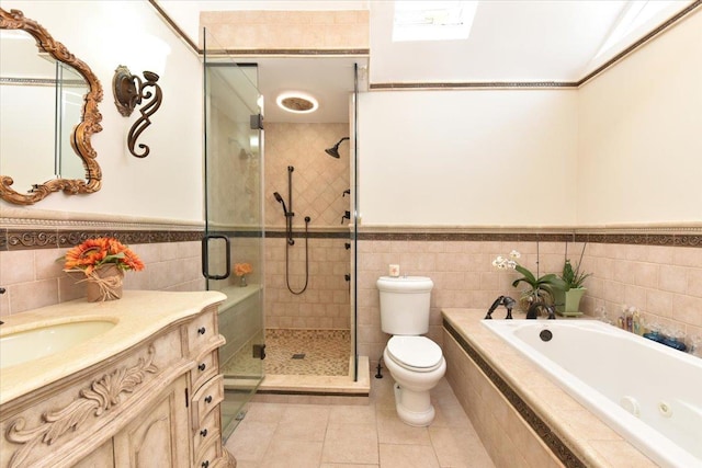 full bathroom featuring toilet, vanity, tile walls, tile patterned floors, and plus walk in shower