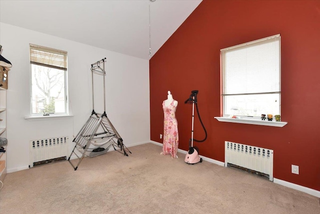 miscellaneous room with carpet, vaulted ceiling, and radiator heating unit