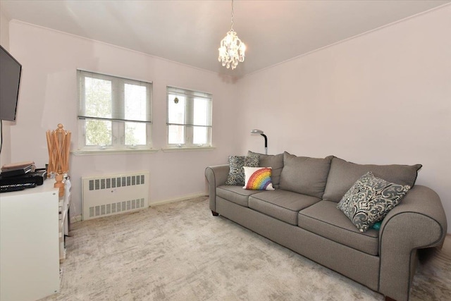 carpeted living room featuring radiator and a chandelier